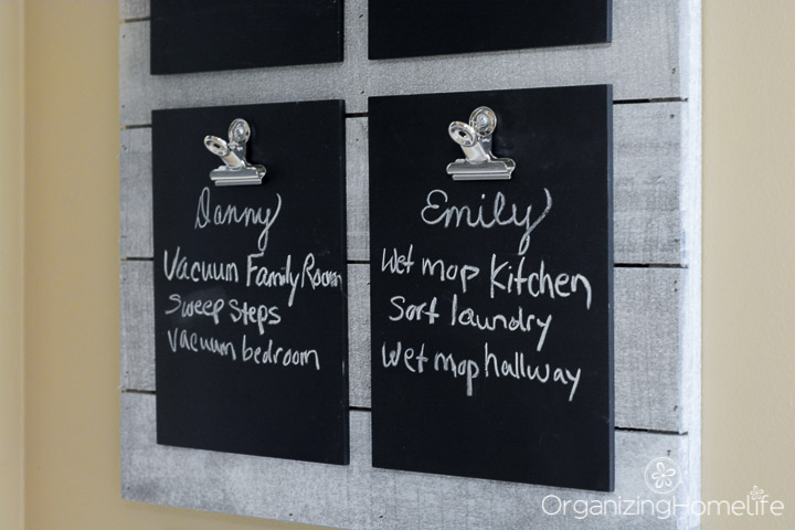 Chores for teens listed on chalk clipboards in kitchen